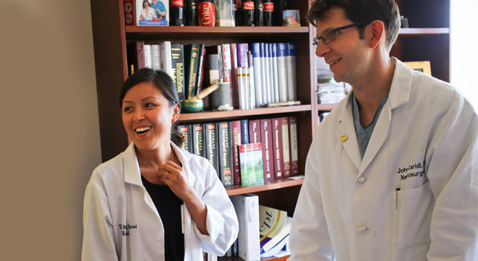 image of Dr. Caridi and faculty member in an office setting