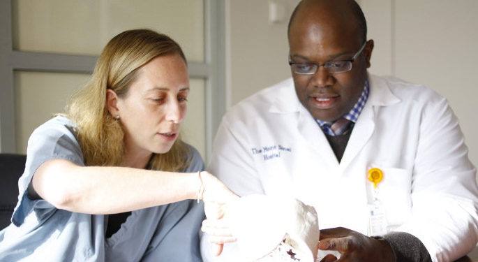 image of physicians discussing 3D printed model of brain
