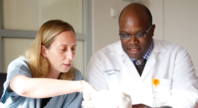 Image of physician and nurse reviewing 3D model of brain