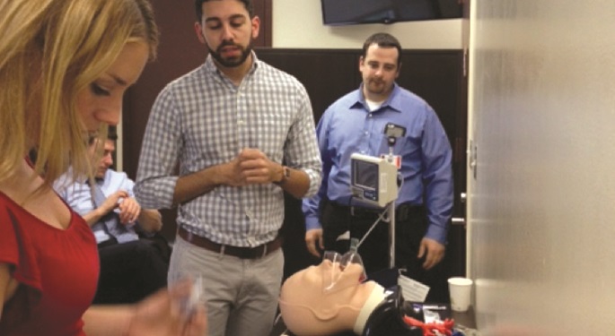 Men and woman participating in medical simulation