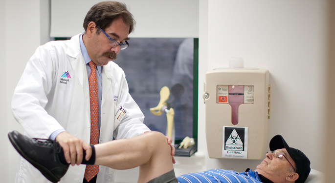 Orthopedic surgeon, Dr. Michael Bronson, with male joint replacement patient