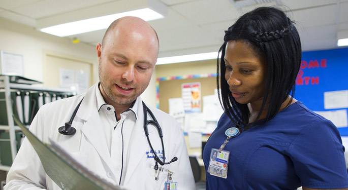 image of doctor speaking with staff member