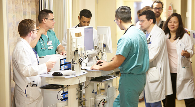 Doctors and nurses around lab equipment