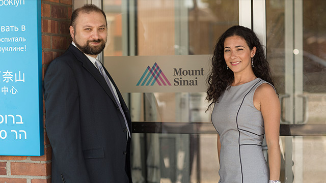 Community Outreach man and woman standing at entrance of building