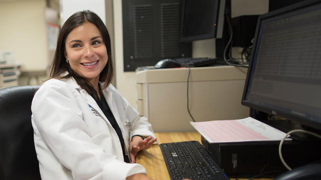 doctor smiling at desk