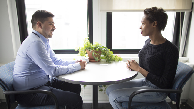 doctor and patient sitting across from one another at roundtable