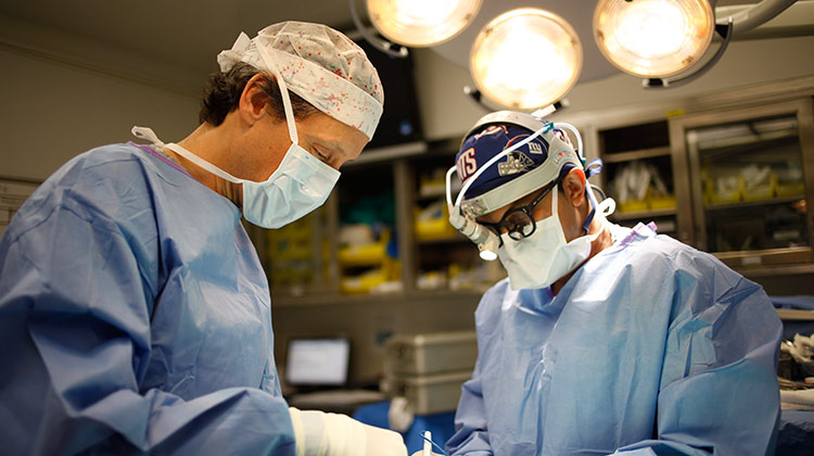 Image of two doctors performing surgery