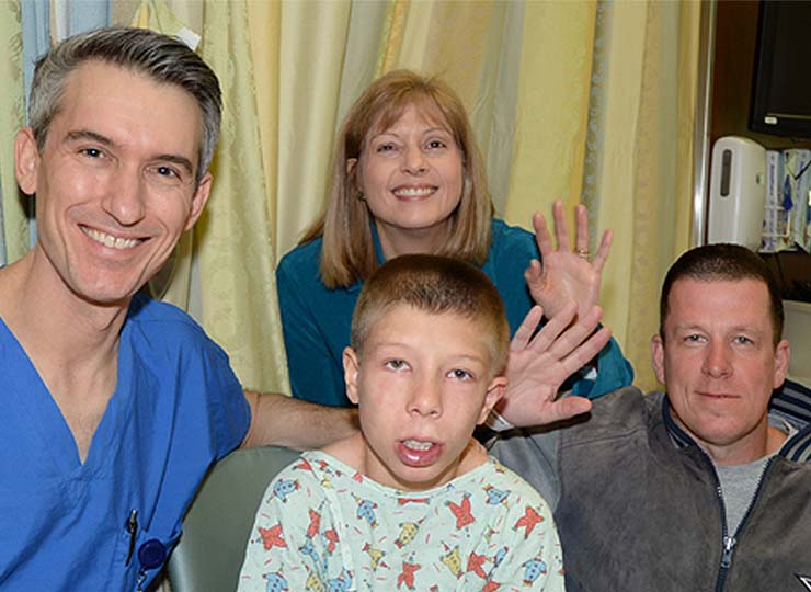 Photo of Image of doctor Levitin with boy and and his family