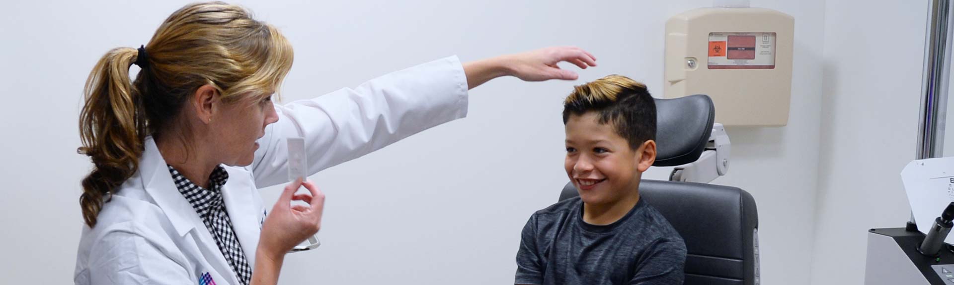 Image of doctor examining young boy